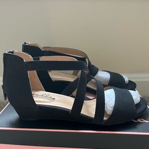 Black sandals with 1 inch heel. Never worn.
